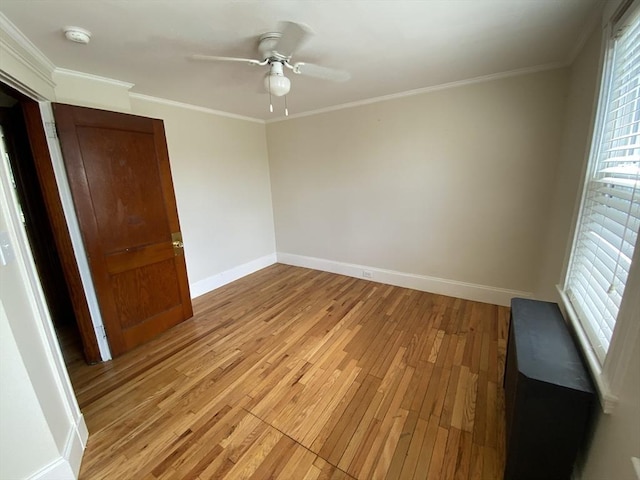 295 Atlantic, Quincy, MA 02171 - empty room with a smoke detector, light wood-type flooring, ceiling fan, and ornamental molding