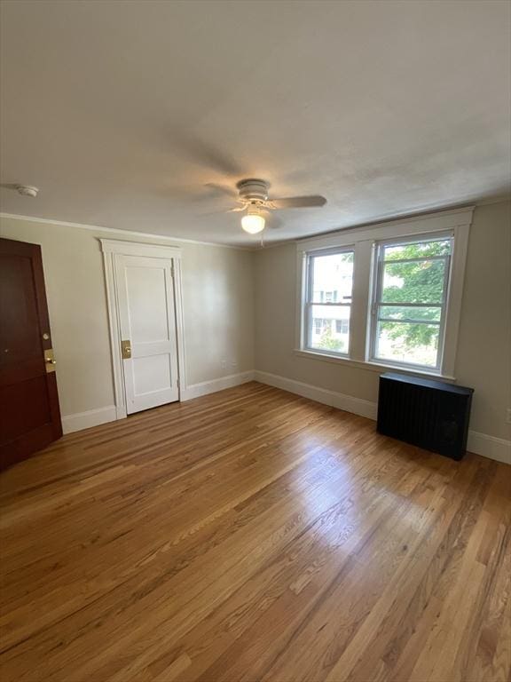 295 Atlantic, Quincy, MA 02171 - spare room featuring ceiling fan, light wood-style flooring, and radiator heating unit