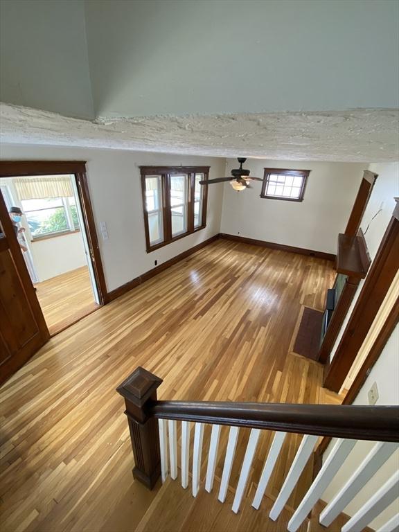295 Atlantic, Quincy, MA 02171 - foyer entrance featuring wood finished floors, ceiling fan, and stairs