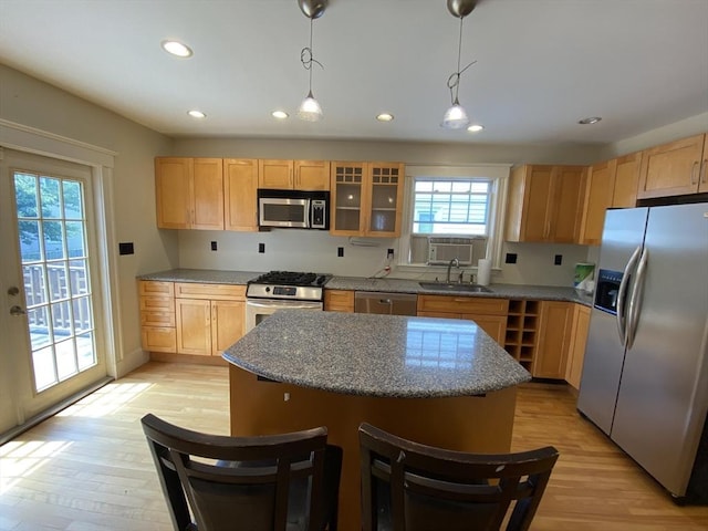 295 Atlantic, Quincy, MA 02171 - kitchen with appliances with stainless steel finishes, light brown cabinets, recessed lighting, light wood-style flooring, and glass insert cabinets