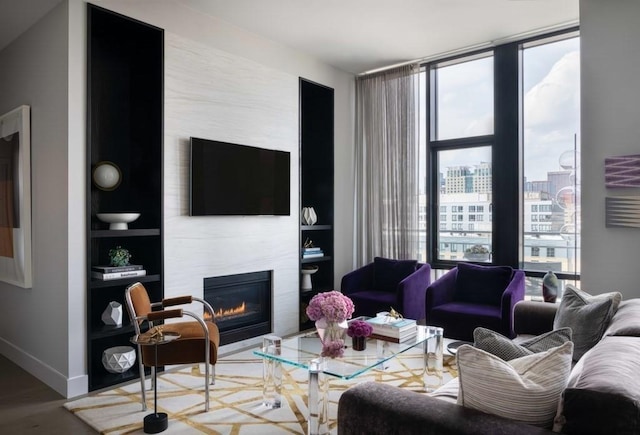 living room with expansive windows and a large fireplace