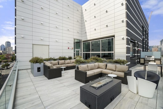exterior space with area for grilling, outdoor lounge area, and a view of city