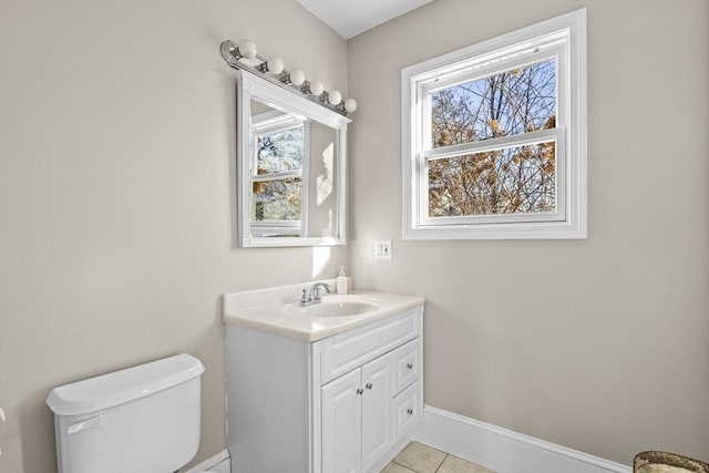 bathroom featuring vanity, tile patterned floors, toilet, and a healthy amount of sunlight