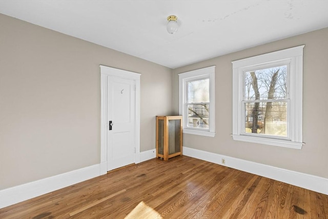 empty room with hardwood / wood-style flooring