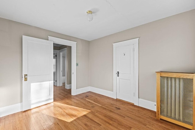 unfurnished room with hardwood / wood-style flooring