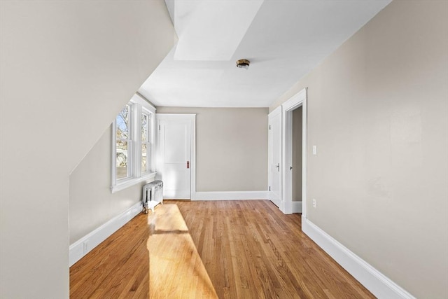 hall featuring radiator and light hardwood / wood-style flooring