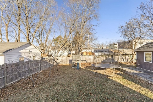 view of yard featuring a playground and a trampoline