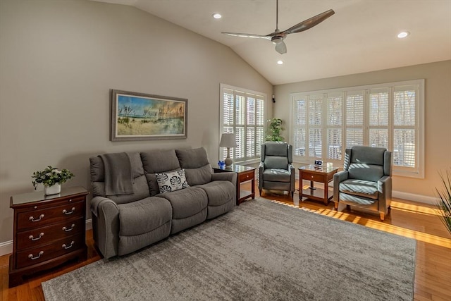 living area with baseboards, vaulted ceiling, wood finished floors, and recessed lighting