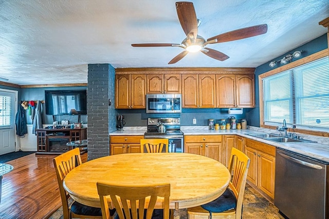 214 Hovenden Ave, Brockton, MA 02302 - kitchen with appliances with stainless steel finishes, a ceiling fan, light countertops, a textured ceiling, and brown cabinetry