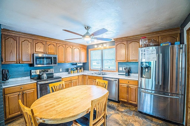 214 Hovenden Ave, Brockton, MA 02302 - kitchen featuring appliances with stainless steel finishes, ceiling fan, light countertops, and dark stone finish floors