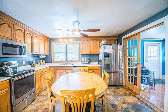 214 Hovenden Ave, Brockton, MA 02302 - kitchen featuring stainless steel appliances, light countertops, ceiling fan, and plenty of natural light
