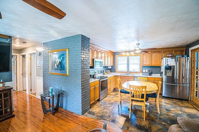 214 Hovenden Ave, Brockton, MA 02302 - kitchen featuring appliances with stainless steel finishes, light countertops, ceiling fan, dark wood-type flooring, and a textured ceiling