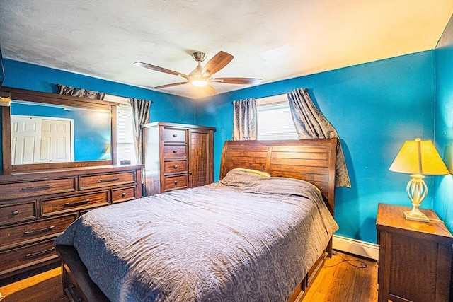 214 Hovenden Ave, Brockton, MA 02302 - bedroom featuring wood finished floors, a baseboard heating unit, and ceiling fan