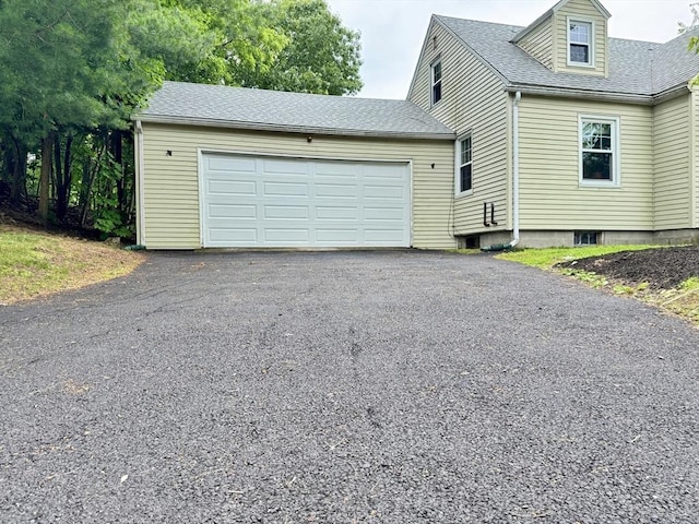 169 Beauchamp Ter, Chicopee, MA 01020 - view of property exterior featuring asphalt driveway, a garage, and a shingled roof