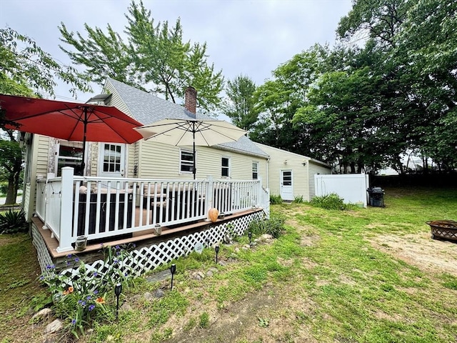 169 Beauchamp Ter, Chicopee, MA 01020 - rear view of property with a wooden deck, a chimney, an outdoor fire pit, and roof with shingles