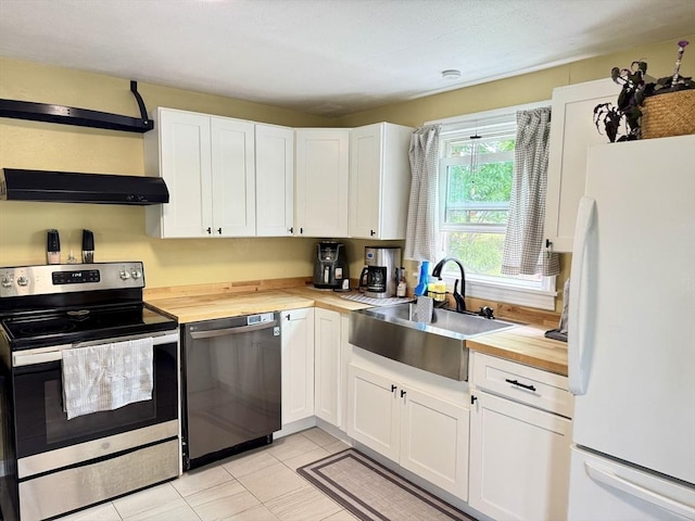 169 Beauchamp Ter, Chicopee, MA 01020 - kitchen with appliances with stainless steel finishes, butcher block counters, exhaust hood, and white cabinetry
