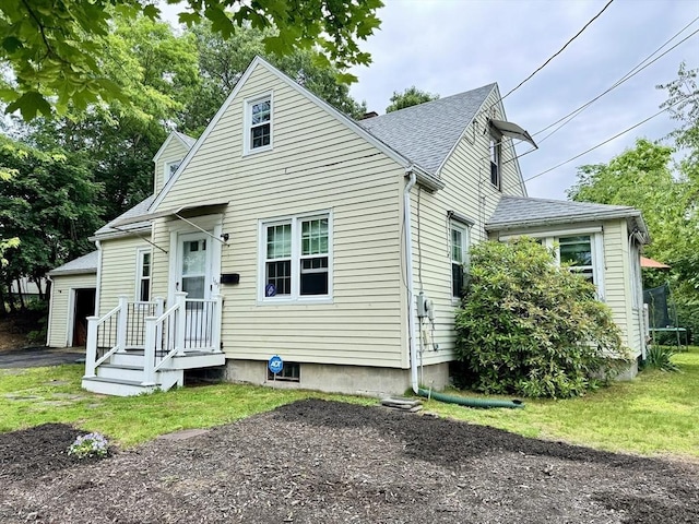 169 Beauchamp Ter, Chicopee, MA 01020 - view of front facade with roof with shingles, a garage, and an outbuilding