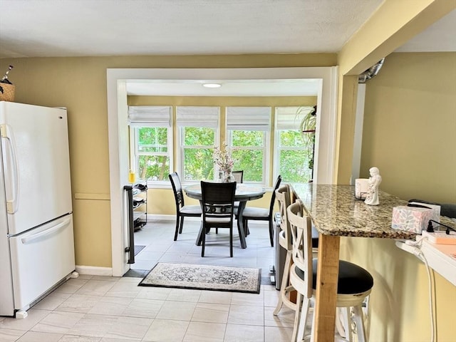 169 Beauchamp Ter, Chicopee, MA 01020 - dining area with light tile patterned floors and baseboards