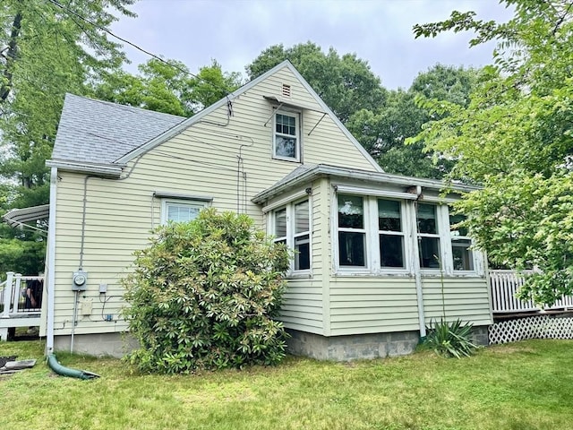 169 Beauchamp Ter, Chicopee, MA 01020 - back of house featuring a deck, roof with shingles, and a yard