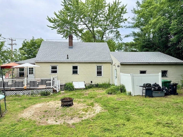 169 Beauchamp Ter, Chicopee, MA 01020 - rear view of property featuring a fire pit, a deck, a chimney, and a shingled roof