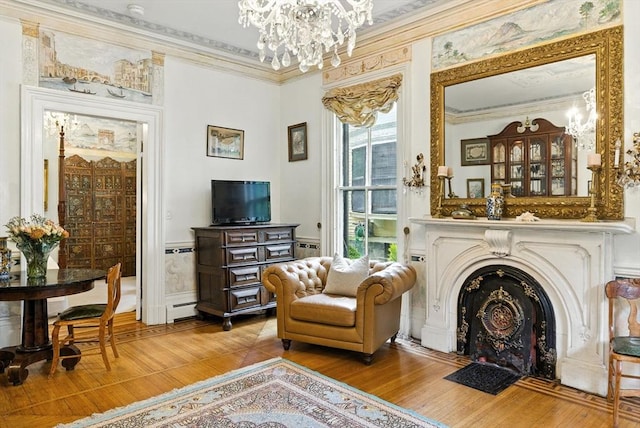 338 Harvard St Unit 1, Cambridge, MA 02139 - sitting room with ornamental molding, a chandelier, wood finished floors, a fireplace with flush hearth, and a wainscoted wall