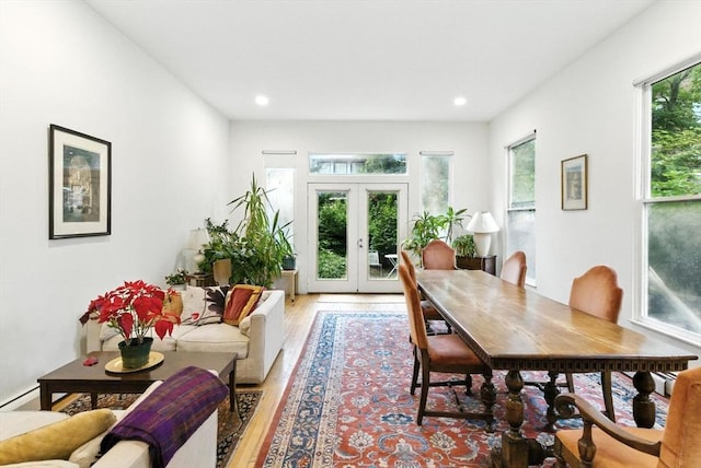 338 Harvard St Unit 1, Cambridge, MA 02139 - dining space with light wood-style flooring, french doors, recessed lighting, and baseboard heating