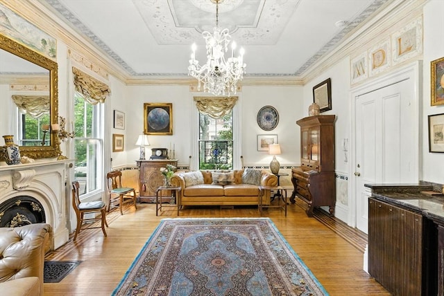 338 Harvard St Unit 1, Cambridge, MA 02139 - sitting room with light wood-style floors, a chandelier, a tray ceiling, and crown molding