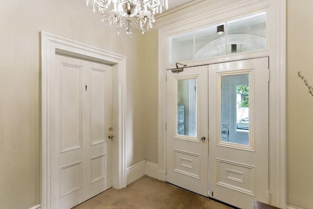338 Harvard St Unit 1, Cambridge, MA 02139 - carpeted foyer featuring a chandelier and french doors