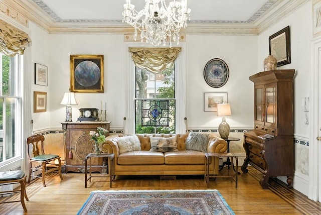 338 Harvard St Unit 1, Cambridge, MA 02139 - sitting room with light wood finished floors, a chandelier, healthy amount of natural light, and ornamental molding