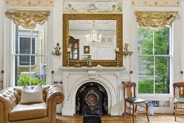 338 Harvard St Unit 1, Cambridge, MA 02139 - living area featuring a chandelier, ornamental molding, and a fireplace