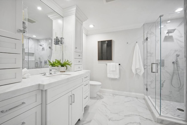 bathroom with marble finish floor, a marble finish shower, crown molding, baseboards, and vanity