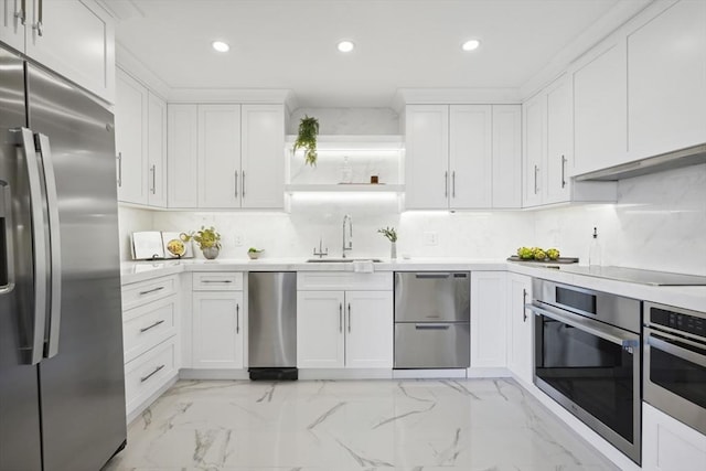 kitchen featuring under cabinet range hood, light countertops, marble finish floor, stainless steel appliances, and a sink