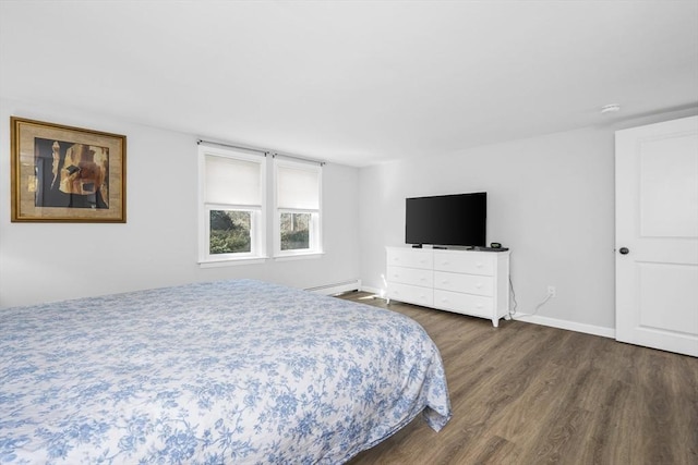 bedroom featuring baseboards, baseboard heating, and wood finished floors