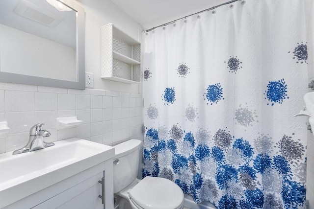 bathroom with toilet, vanity, tile walls, and a shower with shower curtain