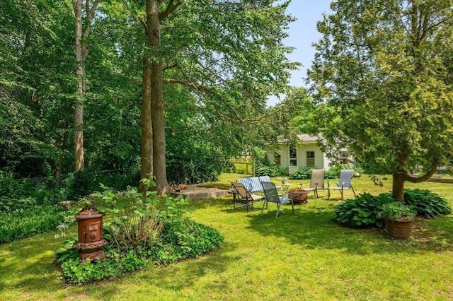 view of yard with an outdoor fire pit