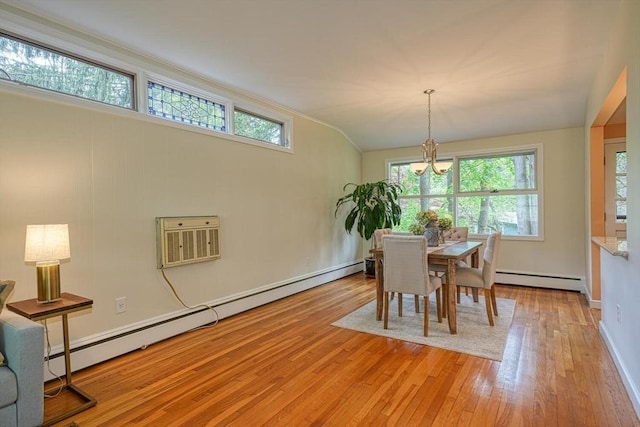 dining space featuring a baseboard radiator, healthy amount of natural light, and light wood-type flooring