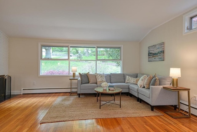 living room featuring vaulted ceiling, a baseboard radiator, light wood-style floors, and a baseboard heating unit