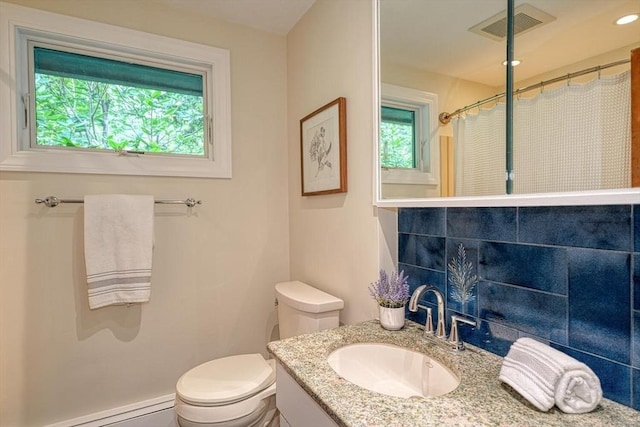 bathroom with toilet, baseboard heating, curtained shower, and vanity