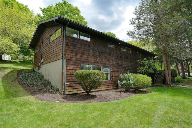 view of home's exterior with a lawn