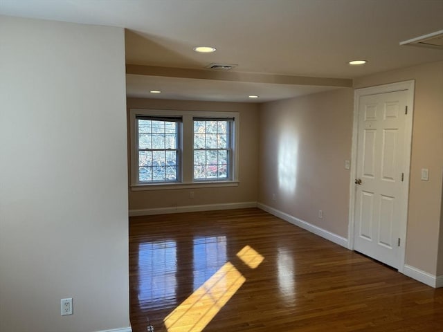 unfurnished room featuring dark hardwood / wood-style flooring