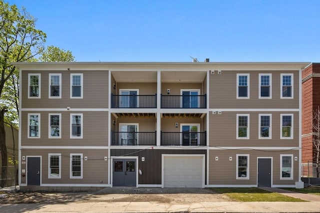 view of building exterior featuring driveway and a garage