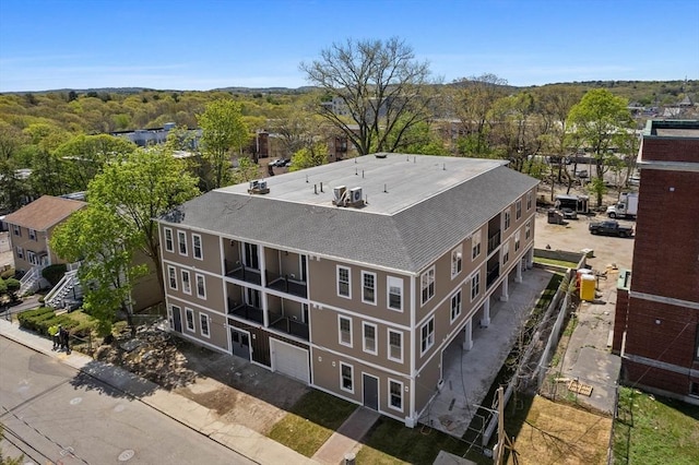 drone / aerial view with a wooded view