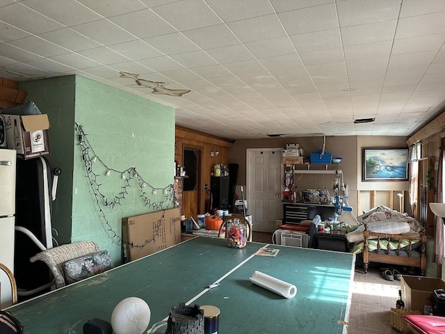 game room with wood walls