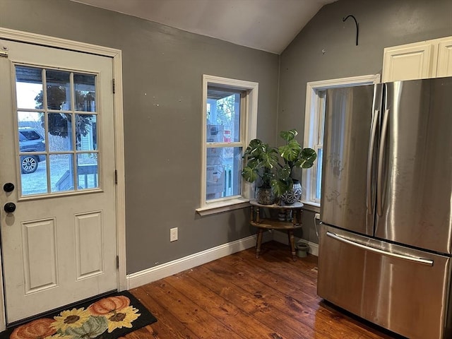 entrance foyer with baseboards, lofted ceiling, and dark wood-type flooring