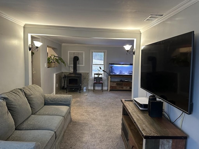 living room with carpet, a wood stove, baseboards, visible vents, and ornamental molding