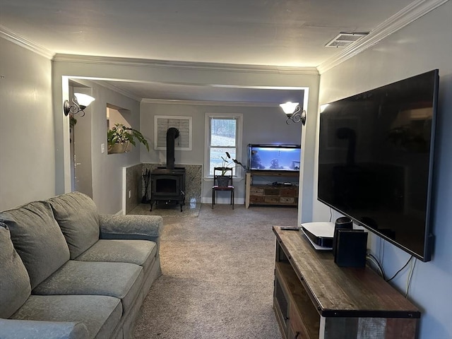 carpeted living area featuring baseboards, ornamental molding, visible vents, and a wood stove