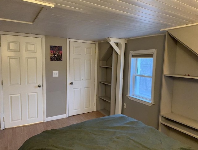 unfurnished bedroom featuring wooden ceiling and wood finished floors