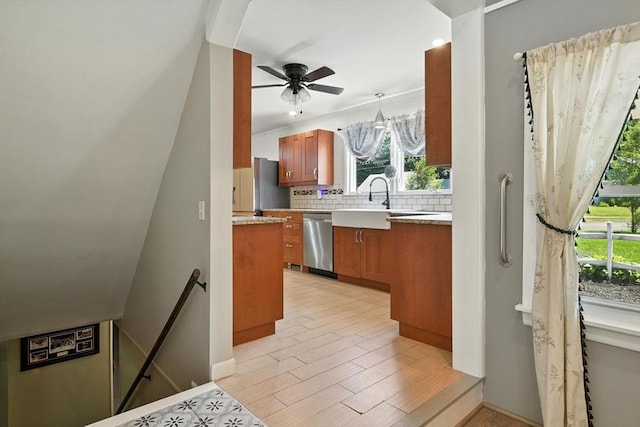 683 Rogers Ave, West Springfield, MA 01089 - kitchen with stainless steel dishwasher, brown cabinets, healthy amount of natural light, and freestanding refrigerator
