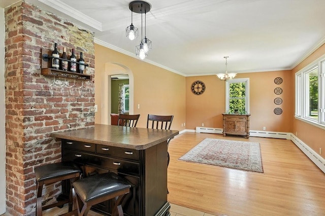 683 Rogers Ave, West Springfield, MA 01089 - dining space featuring a baseboard heating unit, wood finished floors, arched walkways, ornamental molding, and a chandelier