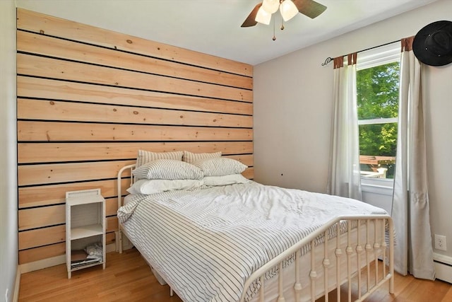 683 Rogers Ave, West Springfield, MA 01089 - bedroom with light wood-style flooring, a baseboard heating unit, and a ceiling fan